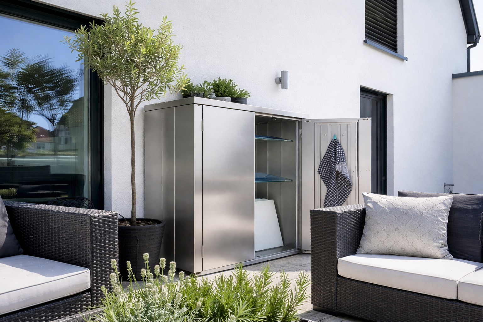 Ein Edelstahlschrank auf der Terrasse bietet wetterfesten Stauraum in moderner Umgebung.