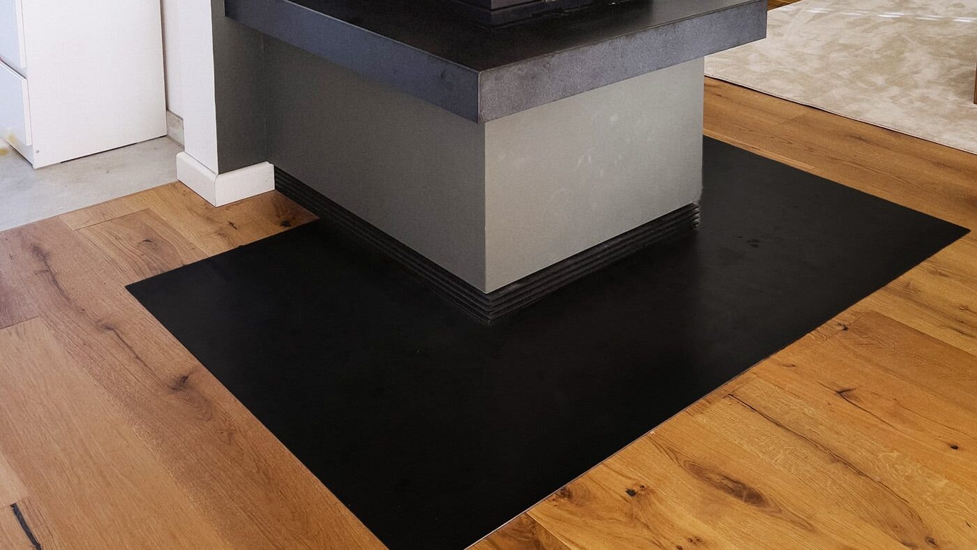 Gezunderter Schwarzstahl setzt einen markanten, robusten Akzent und schützt den Boden vor dem Kamin stilvoll vor Funken.